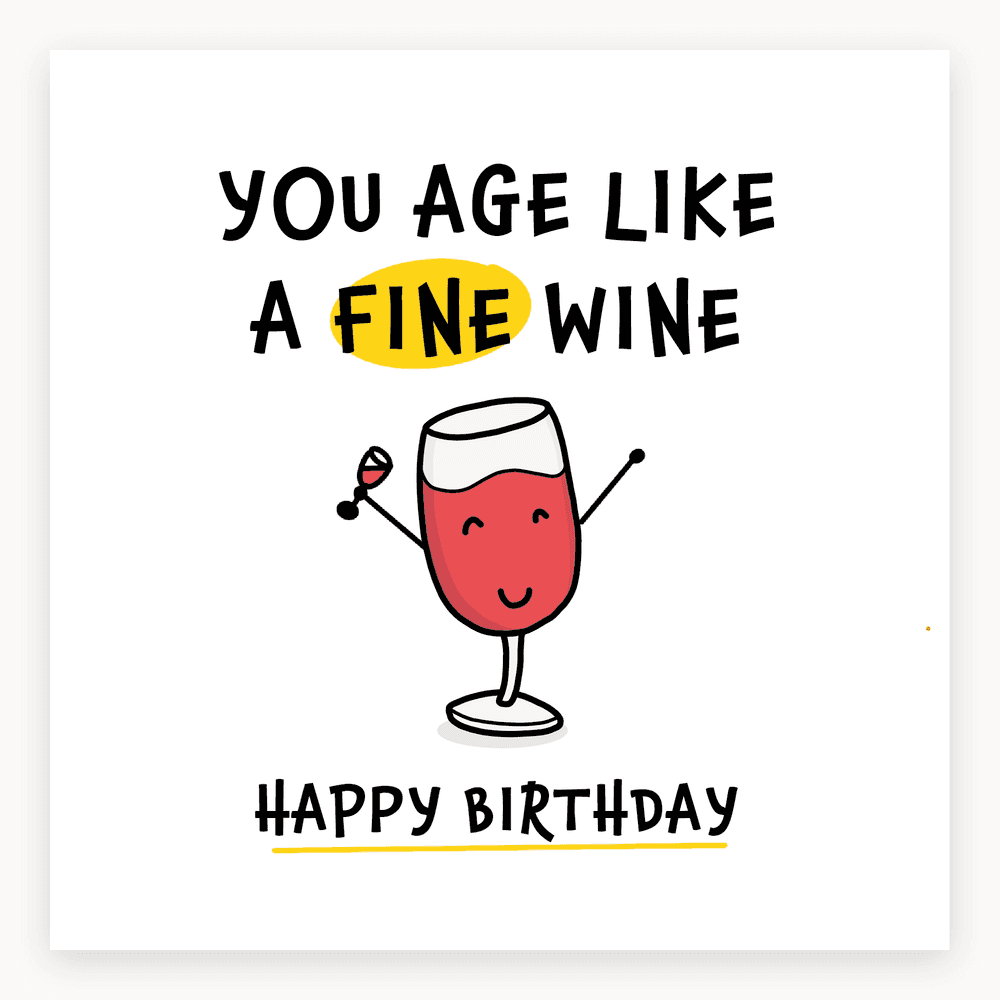 The card lying flat. Illustrated card with a cartoon wine glass, smiling, holding another glass. Text reads 'YOU AGE LIKE A FINE WINE' and 'HAPPY BIRTHDAY'.