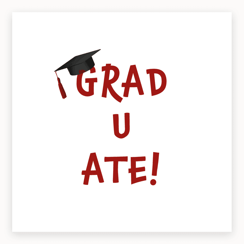 The card lying flat. Graduation card with 'GRAD U ATE!' in red letters, featuring a graduation cap on a white background.