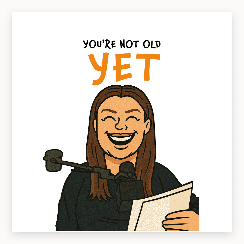 The card lying flat. Illustrated card with a laughing woman at a microphone, text 'YOU'RE NOT OLD YET' in bold, with blue and white colours.