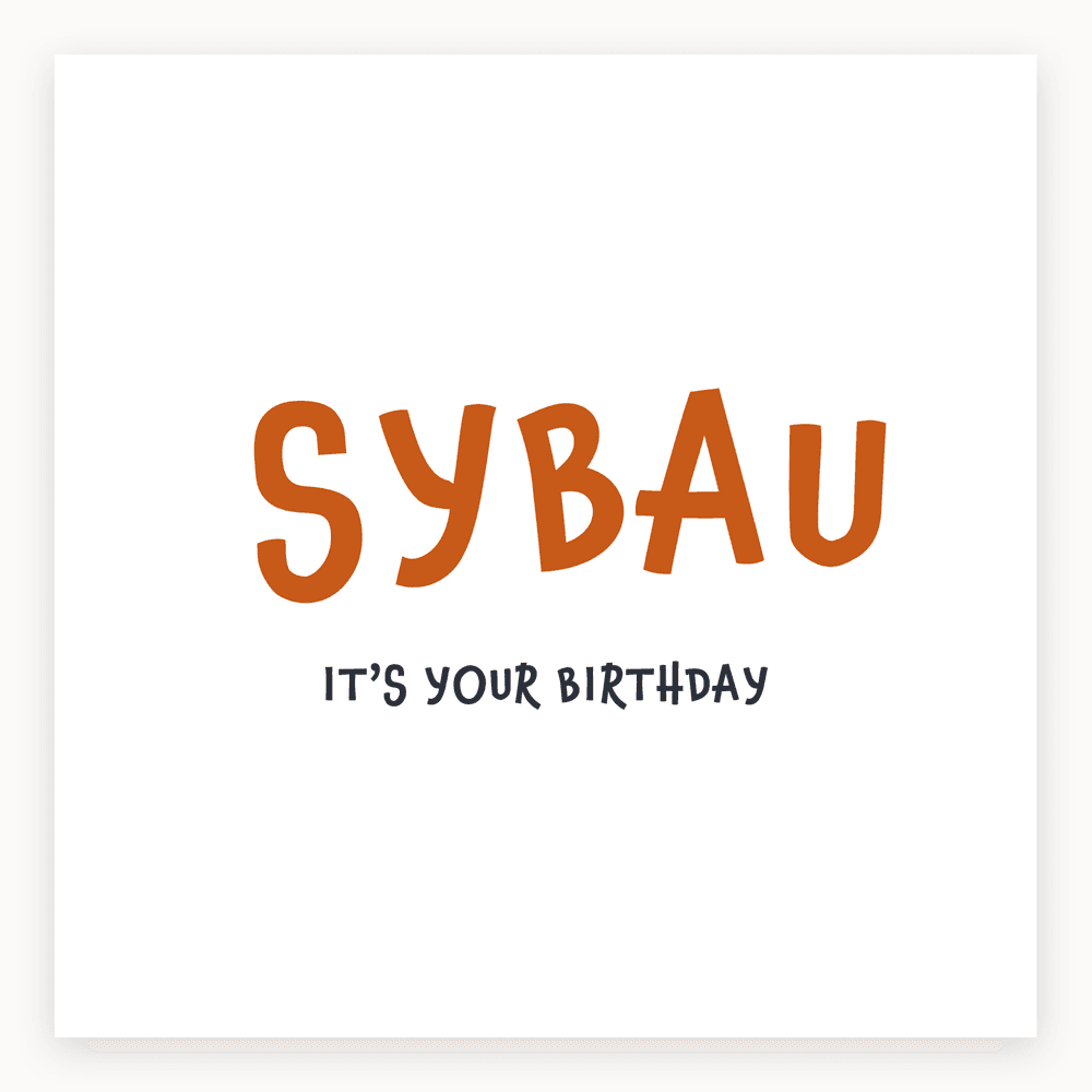 The card lying flat. Birthday card with 'SYBAU' in large orange letters and 'IT'S YOUR BIRTHDAY' in smaller black letters.
