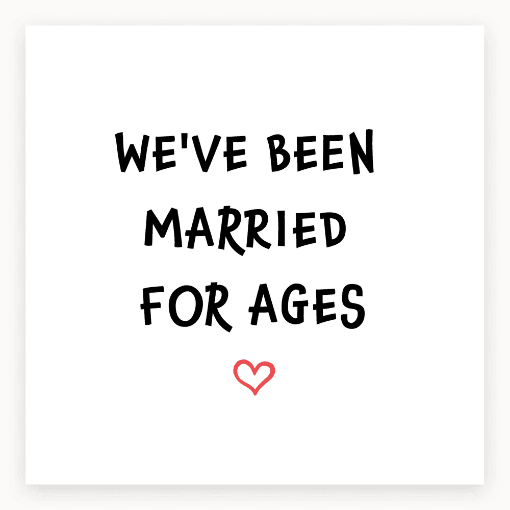 The card lying flat. Anniversary card with bold black text 'WE'VE BEEN MARRIED FOR AGES' and a small red heart on a white background.