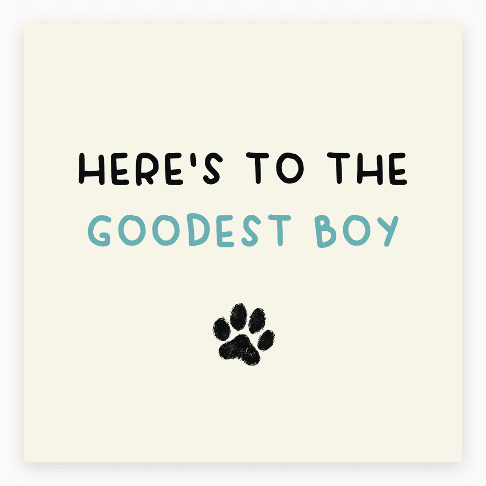 The card lying flat. Card with 'Here's to the Goodest Boy' text and paw print illustration in blue and white.